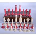 A VICTORIAN ANGLO INDIAN CARVED AND STAINED IVORY CHESS SET. (qty)