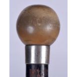 AN EARLY 20TH CENTURY COW HORN HANDLED WALKING CANE, formed with a spherical top. 85 cm long.