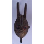 A WEST AFRICAN GIPHOGO TYPE WOODEN MASK, formed with seed inset eyes and boldly carved horns. 62 cm