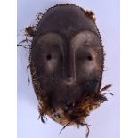 A GOOD CONGOLESE WAREGA WOODEN MASK, formed with a feathered beard. 35 cm x 23 cm.