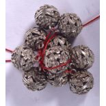 A SET OF CHINESE WHITE METAL BELLS, reticulated forming flowers. Each Bell 1.4 cm wide.