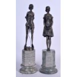 A PAIR OF SPELTER FIGURINES ON MARBLE STAND, a dominatrix together with another. 45 cm & 43 cm. (2)