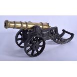 A LATE VICTORIAN/EDWARDIAN CAST IRON FRAMED SIGNAL CANNON. 42 cm wide.