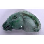 AN EARLY 20TH CENTURY CHINESE CARVED JADEITE PLAQUE, in the form of a ram head. 5.5 cm wide.