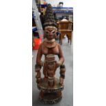 A LARGE NIGERIAN YORUBA POLYCHROMED WOODEN STATUE, formed as a standing figure with three attendant