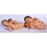 A PAIR OF MID 20TH CENTURY POTTERY CHERUB FIGURINES, set with brass hangings. 16 cm long.