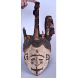 A NIGERIAN YORUBA POLYCHROMED WOODEN MASK, formed with an elaborate headdress. 46 cm long.