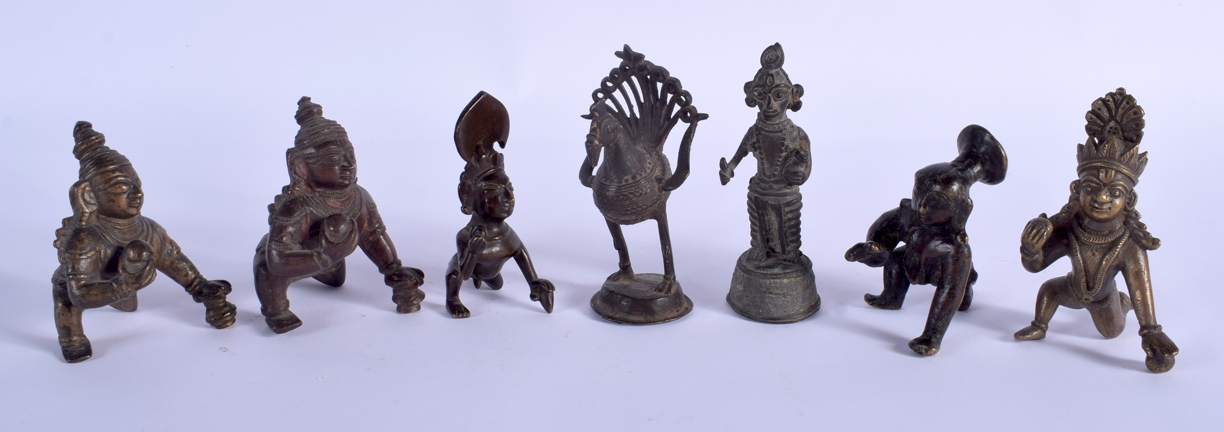 SEVEN 19TH CENTURY INDIAN BRONZE BUDDHISTIC DEITY in various forms and sizes. (7)
