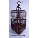 A 1950S CHINESE CARVED WOOD BIRD CAGE with blue and white porcelain bird feeders. 60 cm x 30 cm.