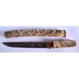 A 19TH CENTURY JAPANESE MEIJI PERIOD CAVED STAG ANTLER TANTO DAGGER carved with figures within land