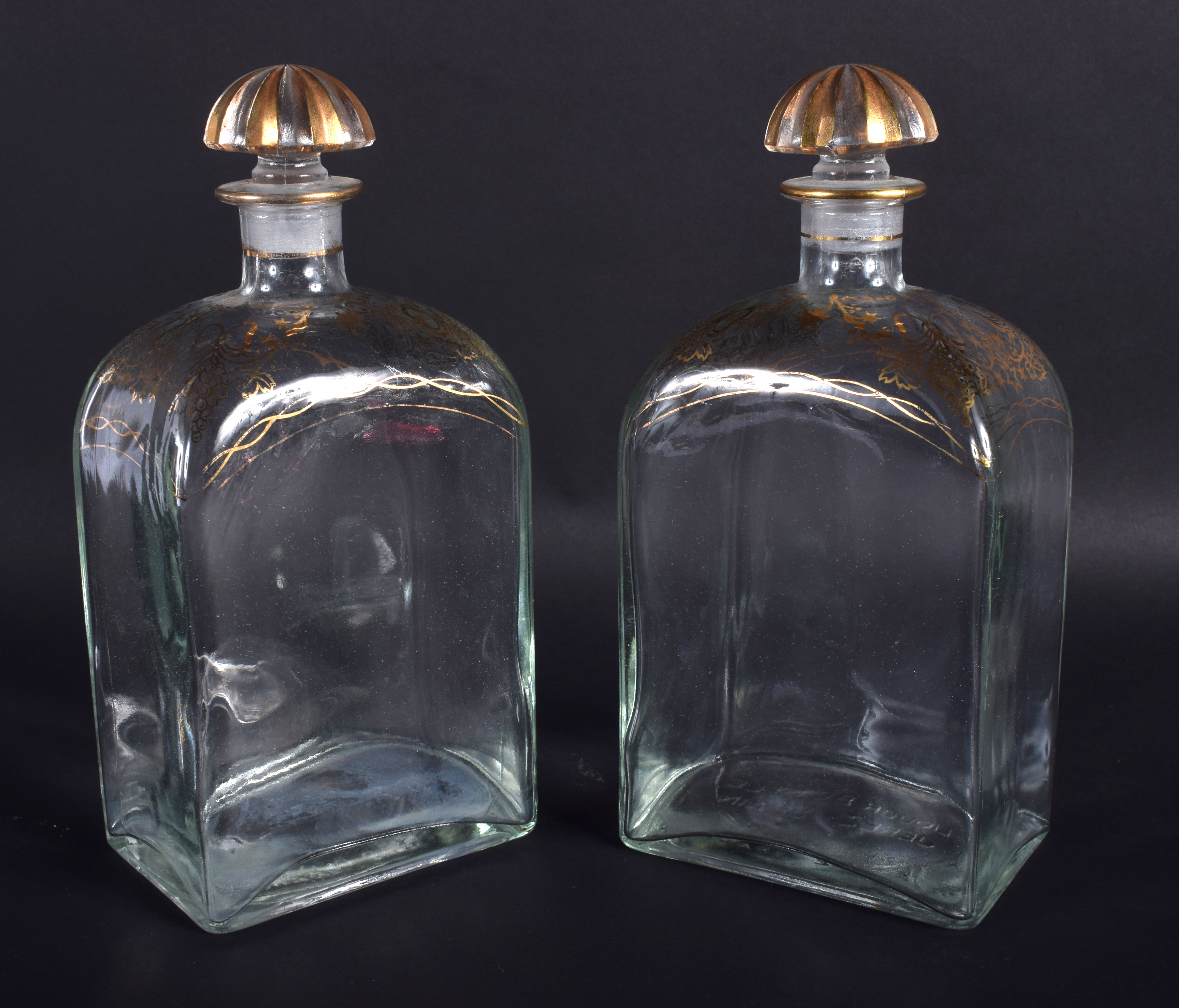 A PAIR OF 19TH CENTURY BOHEMIAN GILDED GLASS LIQUOR DECANTERS. 21 cm high.
