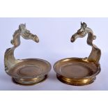 A PAIR OF 19TH CENTURY INDIAN BRONZE DISHES formed with horse heads over a circular bowl. 18 cm x