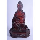 A RARE EARLY 20TH CENTURY CHINESE CARVED RED AMBER FIGURE OF GUANYIN modelled holding a rui sceptre