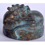 A CHINESE BRONZE COVER, in the form of a curled beast. 5.75 cm wide.