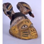 A NIGERIAN YORUBA WOODEN POLYCHROMED GELEDE MASK, formed with an elaborate headdress. 25 cm x 22 cm