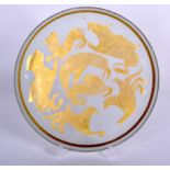 AN IRANIAN GLASS DISH, painted with gold coloured mythical creatures. 23 cm wide.