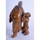 A 19TH CENTURY CHINESE SOAPSTONE FIGURE OF A SCHOLAR modelled beside a child. 14 cm x 5 cm.