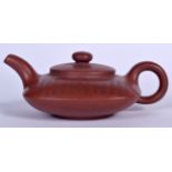 A CHINESE YIXING ZISHA POTTERY TEA POT, incised with calligraphy. 17 cm wide.