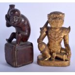 A 19TH CENTURY THAI CARVED GILTWOOD FIGURE OF A BUDDHISTIC GOD together with another carved wood fi