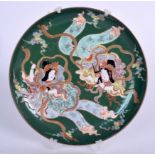 AN UNUSUAL JAPANESE MEIJI PERIOD GREEN GROUND KUTANI PORCELAIN DISH, decorated with two females, si