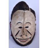 A GOOD NIGERIAN IBIBIO WOODEN POLYCHROMED GELEDE MASK, formed with wool like hair and cloth neck pi
