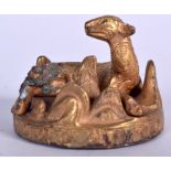 A CHINESE BRONZE BEAST ON STAND, scrolling decoration to body. 6.5 cm wide.