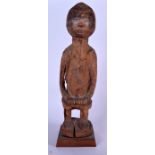 A LARGE WEST AFRICAN CARVED WOODEN STATUE, formed upon a plinth. 57 cm high.