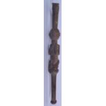 AN AFRICAN CARVED WOODEN ADZE TOOL, formed with a figural handle tugging her breasts. 57 cm long.