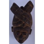 A NIGERIAN YORUBA WOODEN MASK, formed with bulging eyes and traditional headdress. 35 cm x 21 cm.
