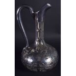 AN ART NOUVEAU SILVER OVERLAID GLASS JUG. 22 cm high.