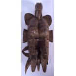 AN IVORY COAST WOODEN SENUFU MASK, formed with twin faces and bird finial. 43 cm long.