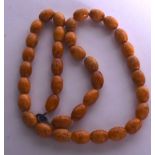 A TURKISH AMBER NECKLACE, weight 59 grams. 64 cm long.