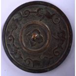 A CHINESE BRONZE HAND MIRROR, decorated in relief with stylised animals. 16 cm wide.