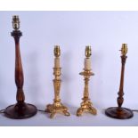 A PAIR OF EDWARDIAN CARVED WOOD CANDLESTICKS converted to lamps, together with another pair. Larges