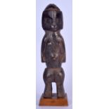 A CONGOLESE BEMBE CARVED WOODEN FIGURE, formed standing with a sloping face. 36.5 cm high.