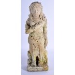 AN INDONESIAN CARVED VOLCANIC TUFF STONE FIGURE OF A STANDING BUDDHISTIC DEITY modelled with one ha