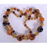 AN AMBER TYPE NECKLACE, formed with white metal spacers. 75 cm long.
