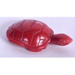 A CHINESE CARVED RED CORAL TORTOISE, formed with its head raised. 4.5 cm wide.