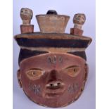 A NIGERIAN YORUBA WOODEN POLYCHROMED GELEDE MASK, carved with a bird finial. 24 cm x 24 cm.