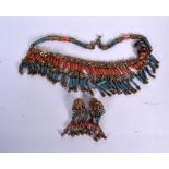 A TIBETAN CORAL AND TURQUOISE NECKLACE, together with a pair of earrings. Necklace 30 cm long. (3)