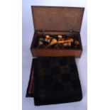 A BOXED CHESS SET, together with material board. Box 9 cm x 27.5 cm.