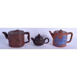 THREE EARLY 20TH CENTURY CHINESE YIXING POTTERY TEAPOTS AND COVERS Qing. Largest 18 cm wide. (3)