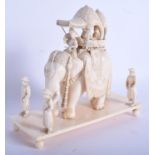 A 19TH CENTURY ANGLO INDIAN CARVED IVORY PROCESSIONAL GROUP modelled as a roaming elephant. 15 cm x