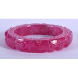 A CHINESE CARVED PURPLE JADE BANGLE 20th Century. 8 cm wide.