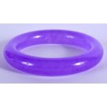 A CHINESE PURPLE JADE BANGLE 20th Century. 8 cm wide.