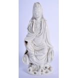 AN 18TH CENTURY CHINESE DEHUA BLANC DE CHINE FIGURE OF GUANYIN modelled upon a rocky outcrop. 24 cm