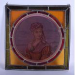 AN ARTS AND CRAFTS STAINED GLASS INSET WINDOW depicting a pretty female. 37 cm square.