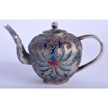 AN EARLY 20TH CENTURY CHINESE TIBETAN SILVER TEAPOT AND COVER decorated with swirling foliage and v