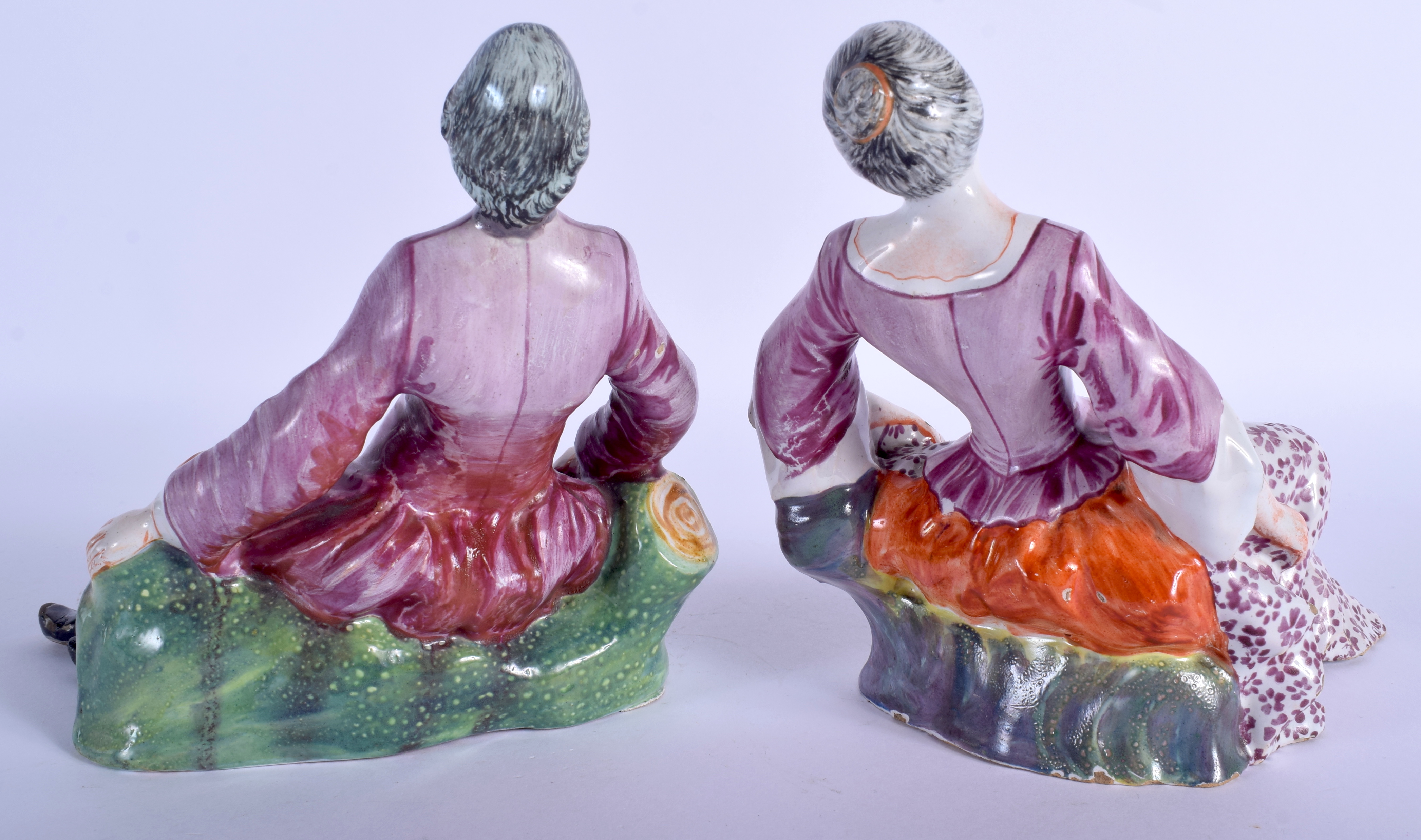 A PAIR OF 18TH CENTURY DUTCH DELFT FIGURES OF A MALE AND FEMALE C1750 modelled resting upon outcrop - Image 2 of 3