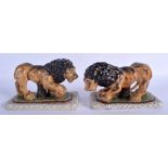 A PAIR OF CONTEMPORARY STAFFORDSHIRE STYLE LIONS modelled upon rectangular bases. 20 cm x 13 cm.